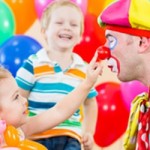 happy children and clown on birthday party